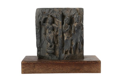 Lot 166 - A GREY SCHIST CARVED RELIEF WITH A YAKSHINI AND TWO MALE FIGURES