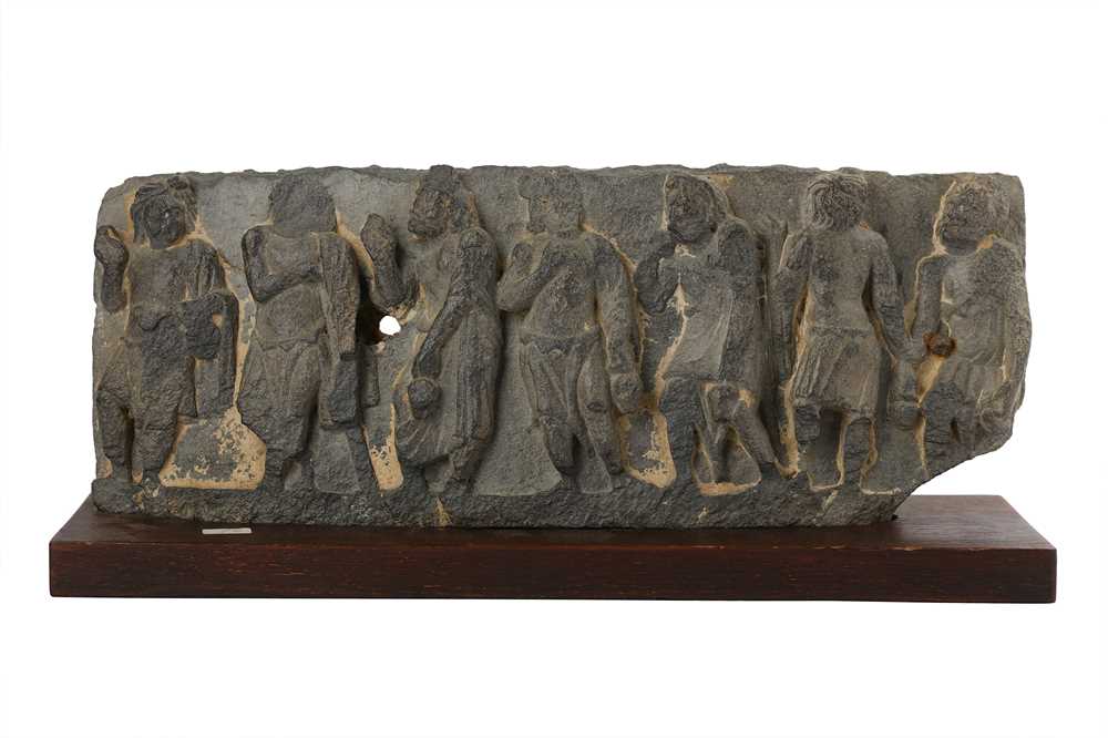 Lot 156 - A GREY SCHIST RELIEF WITH BUDDHIST MONKS CARRYING WATER FLASKS