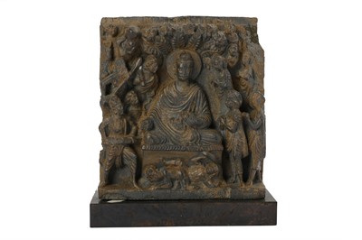 Lot 150 - A GREY SCHIST RELIEF OF THE BUDDHA BEING ATTACKED BY MARA