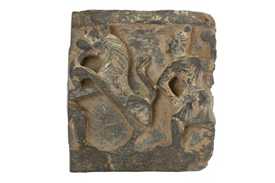 Lot 167 - A GREY SCHIST CARVED FRAGMENT WITH A RAMPANT LION