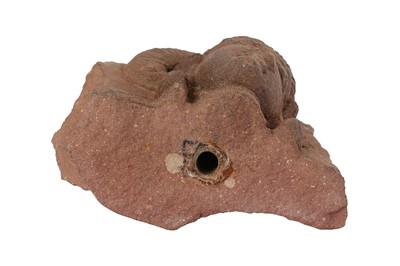 Lot 109 - A MOTTLED RED SANDSTONE CARVING OF A YAKSHINI HEAD