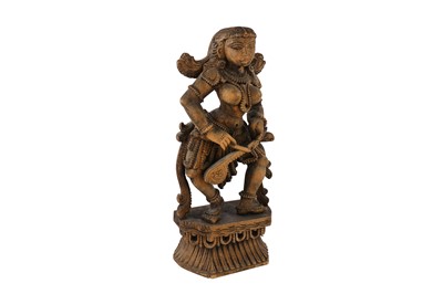 Lot 166 - A carved wooden South Indian statuette of a female musician