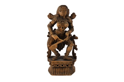 Lot 166 - A carved wooden South Indian statuette of a female musician