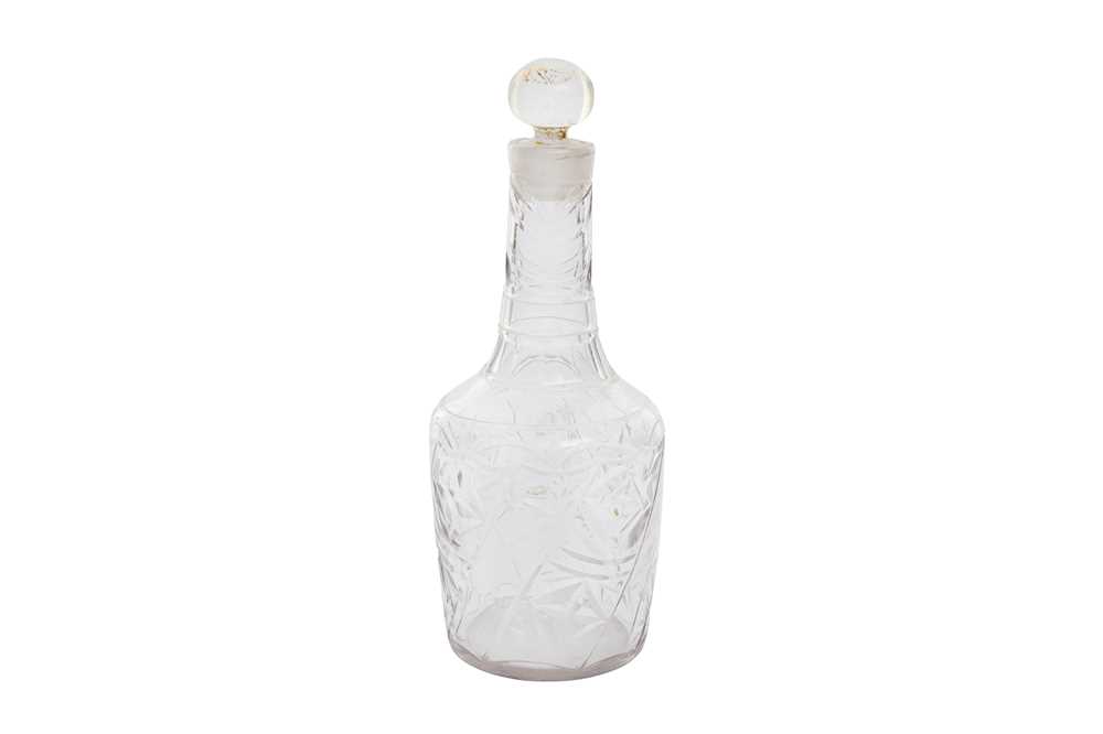 Lot 270 - A CUT AND GILT CLEAR-GLASS BOTTLE WITH STOPPER