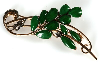 Lot 203 - A antique gold and jade set foliate brooch.