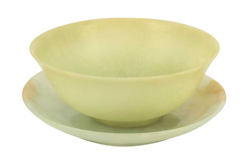 Lot 357 - A celedon jade bowl and green hardstone circular dish