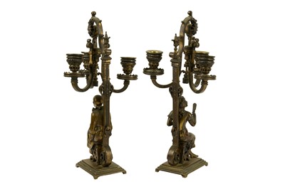 Lot 166 - A pair of late 19th century French gilt bronze candlesticks, circa 1900