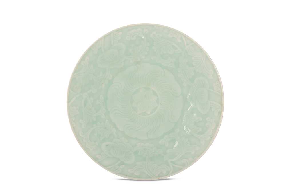 Lot 522 - A CHINESE CELADON-GLAZED FLORAL DISH.