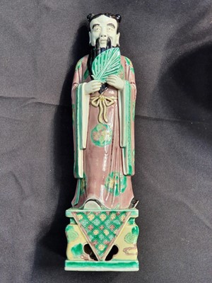 Lot 64 - A CHINESE FAMILLE VERTE BISCUIT FIGURE OF AN IMMORTAL.