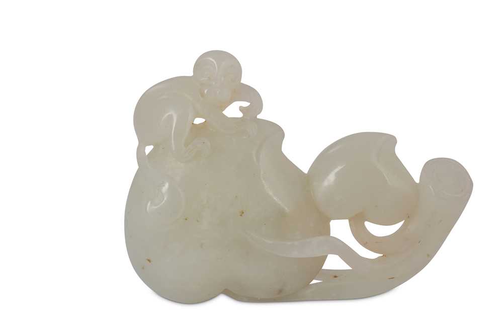 Lot 431 - A CHINESE WHITE JADE 'MONKEY AND PEACHES' CARVING.