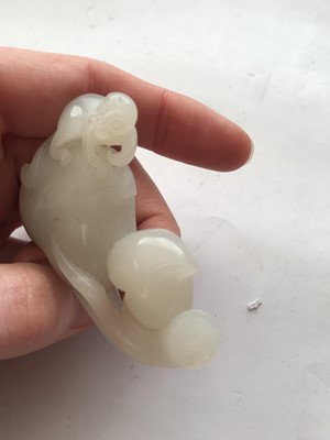 Lot 122 - A CHINESE WHITE JADE 'MONKEY AND PEACHES' CARVING.