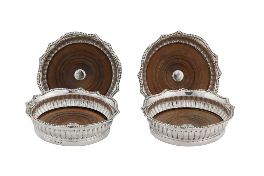 Lot 351 - A set of four George III sterling silver wine coasters, Sheffield 1807 by Samuel Kirby & Co
