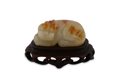 Lot 646 - A CHINESE PALE CELADON JADE CARVING OF A LION.