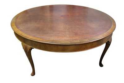 Lot 438 - A circa 1930's large circular walnut and tooled brown leather library table