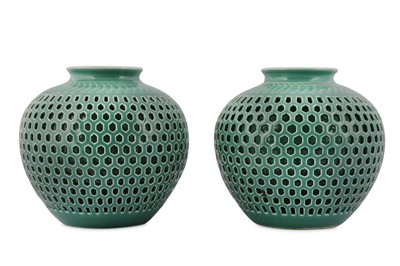 Lot 899 - A PAIR OF CHINESE RETICULATED CELADON-GLAZED JARS.