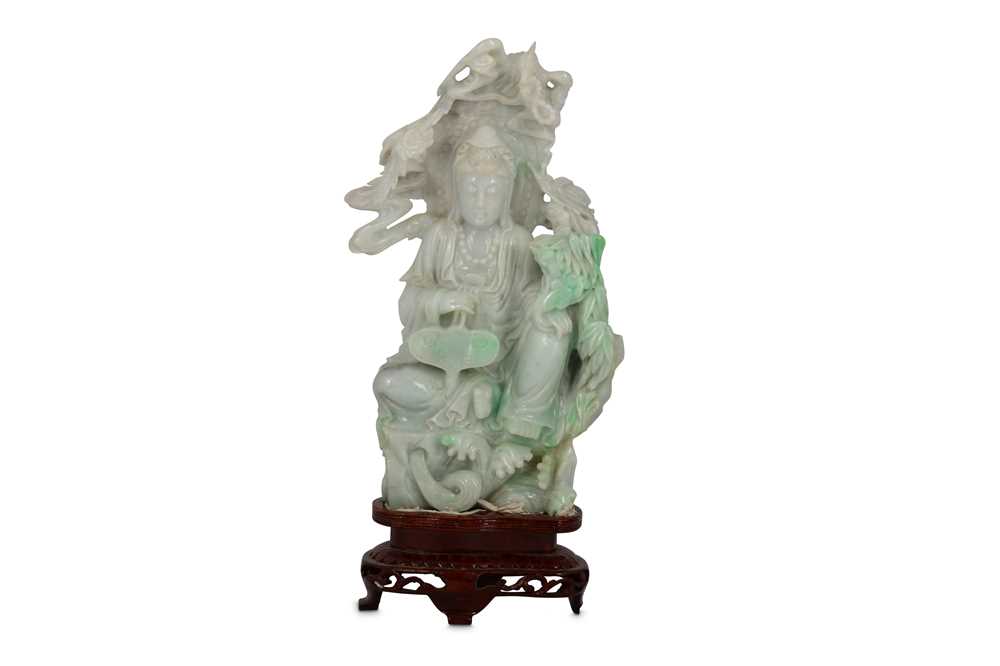 Lot 194 - A CHINESE JADEITE CARVING OF A SEATED GUANYIN.