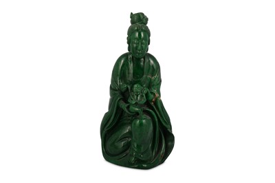 Lot 667 - A CHINESE GREEN STONE FIGURE OF GUANYIN WITH A BOY.