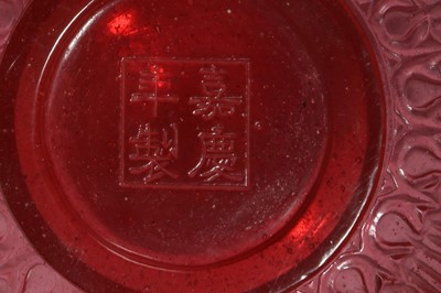 Lot 20 - A CHINESE PEKING GLASS RUBY RED TEA BOWL AND COVER.
