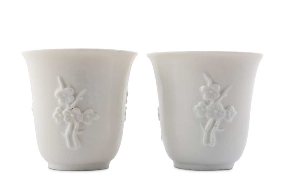 Lot 34 - A PAIR OF CHINESE BLANC-DE-CHINE 'PRUNUS' CUPS.