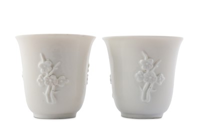 Lot 34 - A PAIR OF CHINESE BLANC-DE-CHINE 'PRUNUS' CUPS.