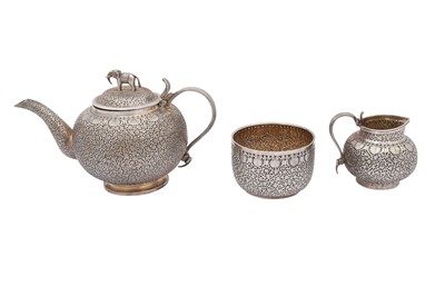 Lot 210 - A THREE-PIECE INDIAN SILVER TEA SET