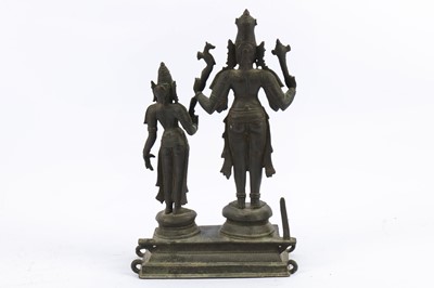 Lot 201 - A CHOLA-REVIVAL BRONZE PROCESSIONAL STATUE OF SHIVA AND PARVATI