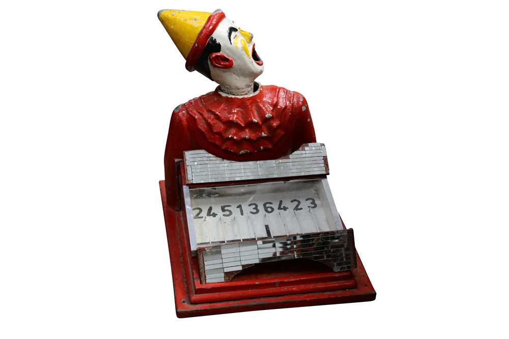 Lot 358 - A early 20th century cast iron fairground / arcade 'Laughing Clown' rolling ball game
