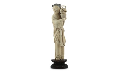 Lot 604 - λ A CHINESE IVORY FIGURE OF A YOUTH.