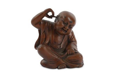 Lot 680 - A CHINESE WOOD CARVING OF A BOY CLEANING HIS EAR.