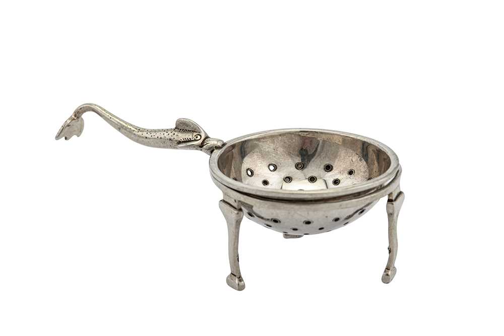 Lot 325 - A George V Scottish sterling silver Traprain Hoard tea strainer on stand, Edinburgh 1925 by Brook and Sons