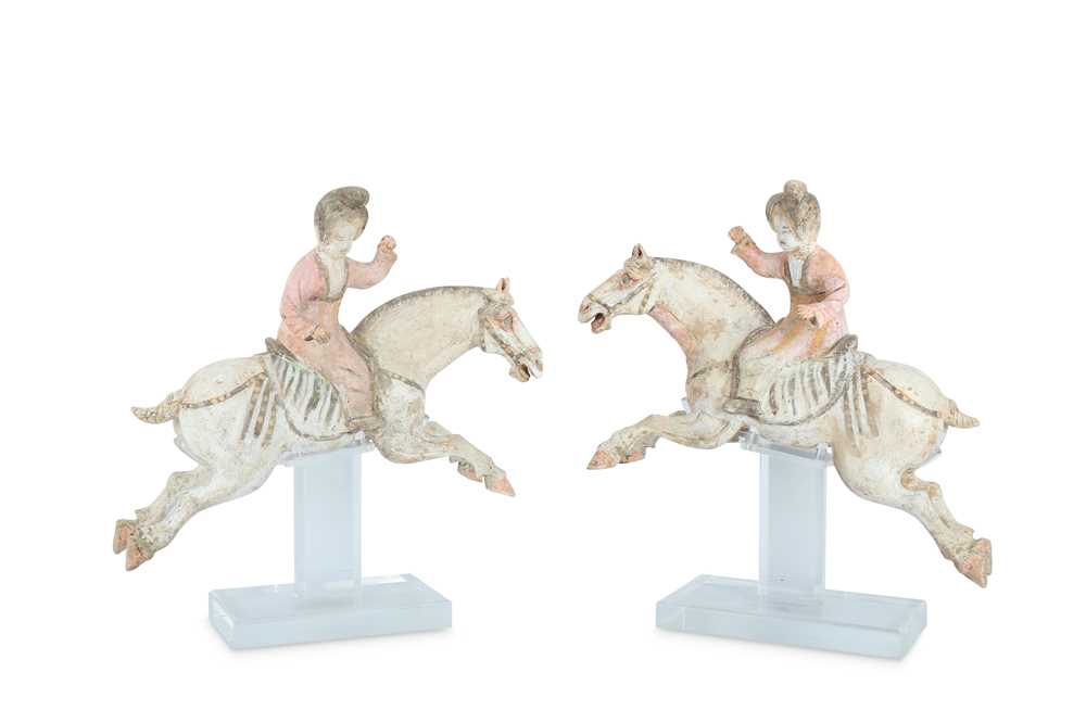 Lot 316 - A PAIR OF CHINESE POTTERY FIGURES OF FEMALE POLO PLAYERS.