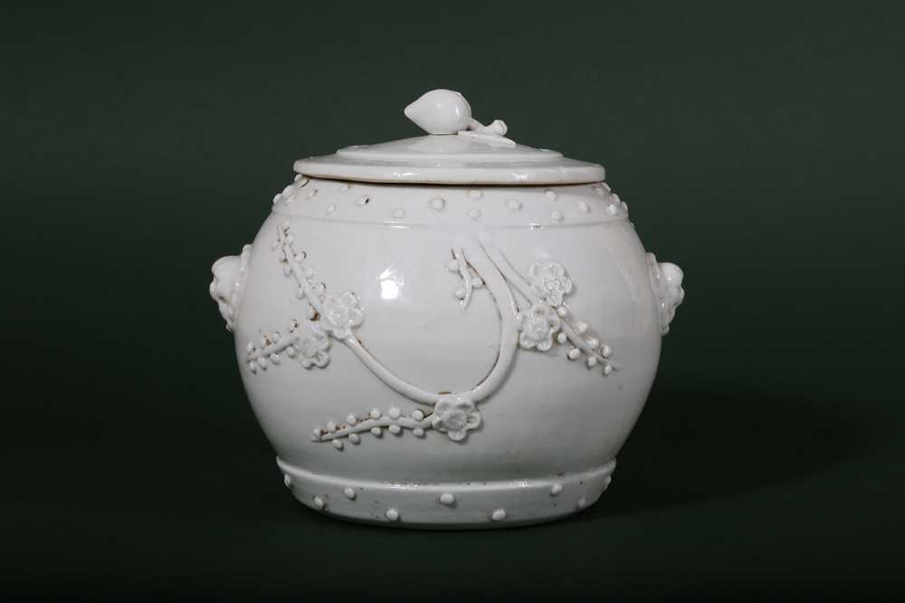 Lot 12 - A CHINESE BLANC-DE-CHINE 'PRUNUS' JAR AND COVER.