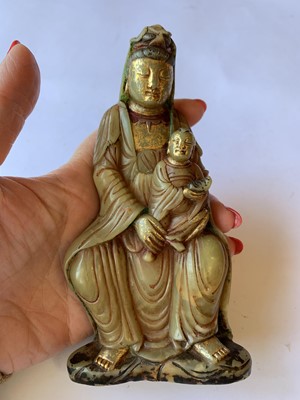 Lot 227 - A CHINESE SOAPSTONE FIGURE OF GUANYIN AND CHILD.