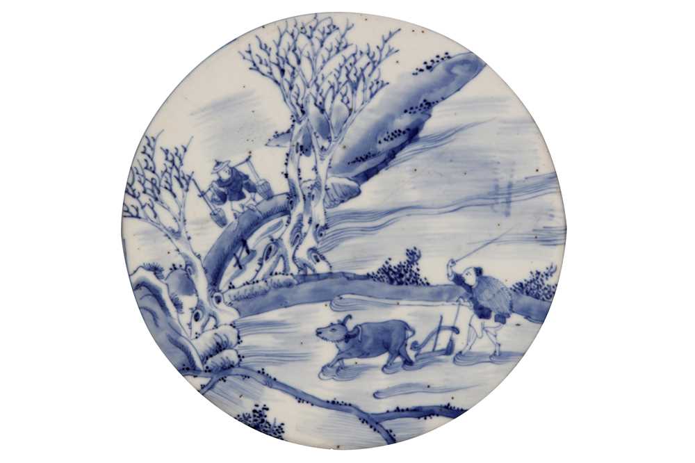 Lot 86 - A CHINESE BLUE AND WHITE CIRCULAR 'PLOUGHMAN' PANEL.