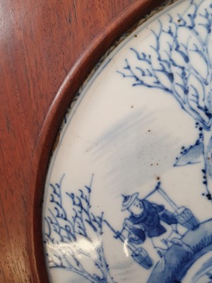 Lot 134 - A CHINESE BLUE AND WHITE CIRCULAR 'PLOUGHMAN' PANEL.
