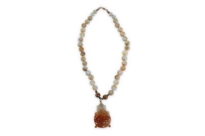Lot 574 - A CHINESE RUSSET JADE NECKLACE.