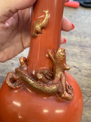 Lot 66 - A PAIR OF SALMON RED-GLAZED 'DRAGON' VASES.