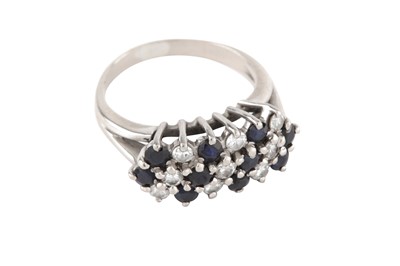 Lot 123 - a sapphire and diamond cluster ring