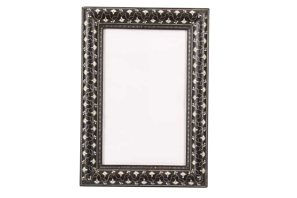 Lot 260 - λ AN INDIAN IVORY AND EBONY PICTURE FRAME