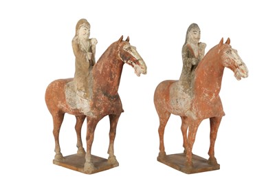 Lot 660 - A PAIR OF CHINESE POTTERY RIDERS ON HORSEBACK.