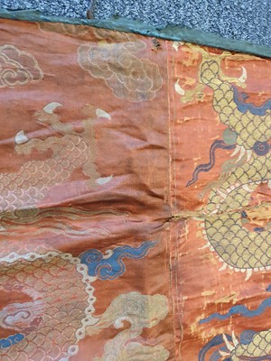 Lot 366 - A CHINESE RED-GROUND 'DRAGON' TEXTILE PANEL.