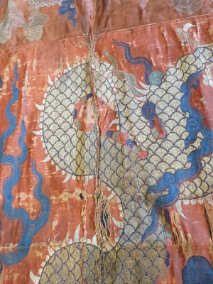 Lot 366 - A CHINESE RED-GROUND 'DRAGON' TEXTILE PANEL.
