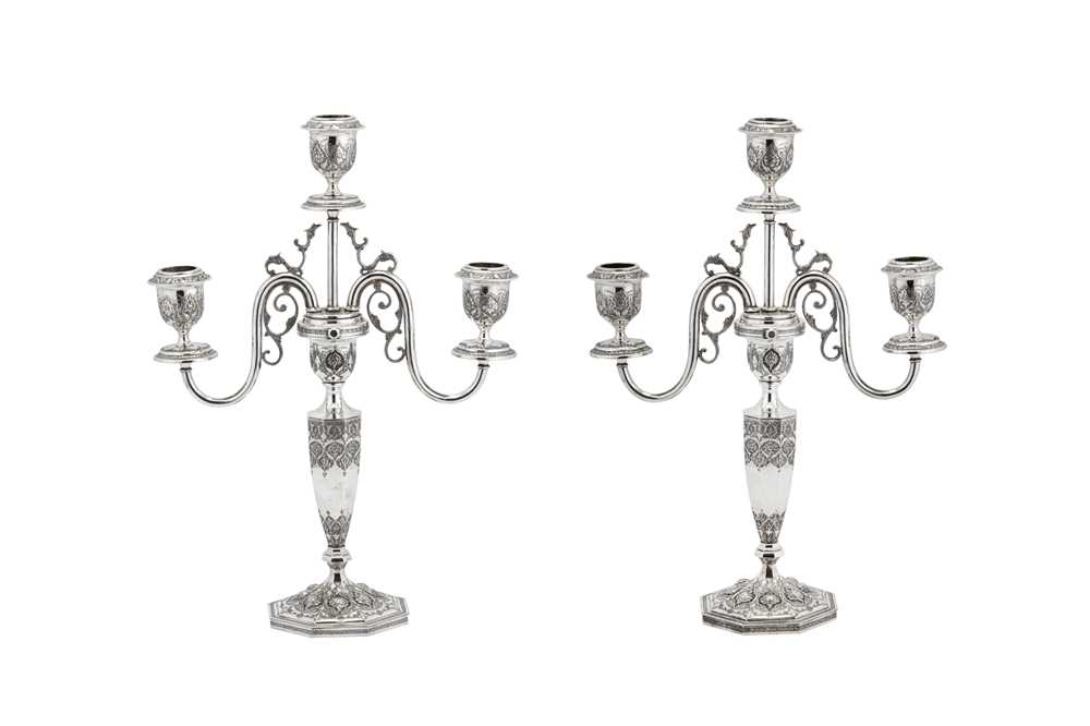 Lot 228 - A pair of early 20th century Iranian (Persian) unmarked silver three light candelabra, Isfahan circa 1930