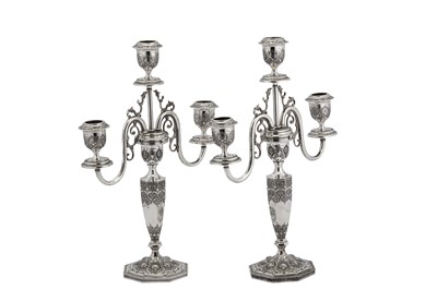 Lot 228 - A pair of early 20th century Iranian (Persian) unmarked silver three light candelabra, Isfahan circa 1930