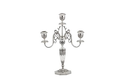 Lot 228 - A pair of early 20th century Iranian (Persian) unmarked silver three light candelabra, Isfahan circa 1930