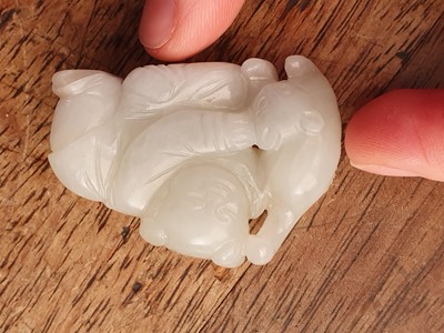 Lot 88 - A CHINESE WHITE JADE 'BOY AND CAT' GROUP.
