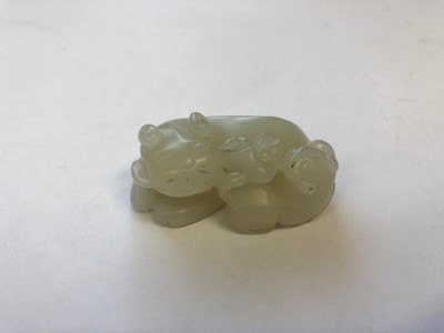 Lot 434 - A CHINESE WHITE JADE 'CATS' CARVING.