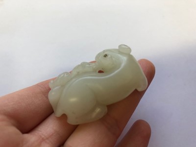 Lot 87 - A CHINESE WHITE JADE 'CATS' CARVING.