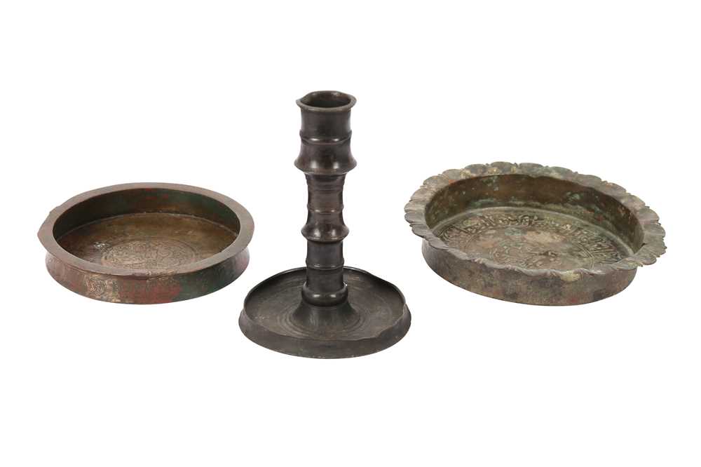 Lot 115 - TWO COPPER ALLOY ENGRAVED DISHES AND A CANDLESTICK