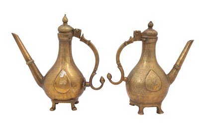 Lot 292 - A NEAR PAIR OF ENGRAVED MINIATURE BRASS EWERS (AFTABEH)